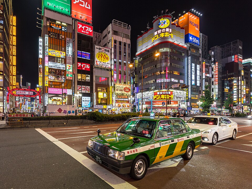 Tokyo: Green and yellow taxi at night in Yasukuni-dori Avenue, Shinjuku, Tokyo